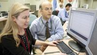 Columbia Neurology visiting physicians working at a computer